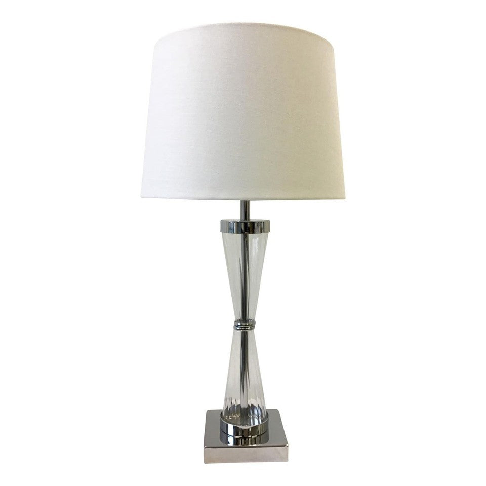 A modern table lamp with a tapered white fabric drum shade, a polished chrome-finished glass body, and a square chrome base, shown against a plain white background.